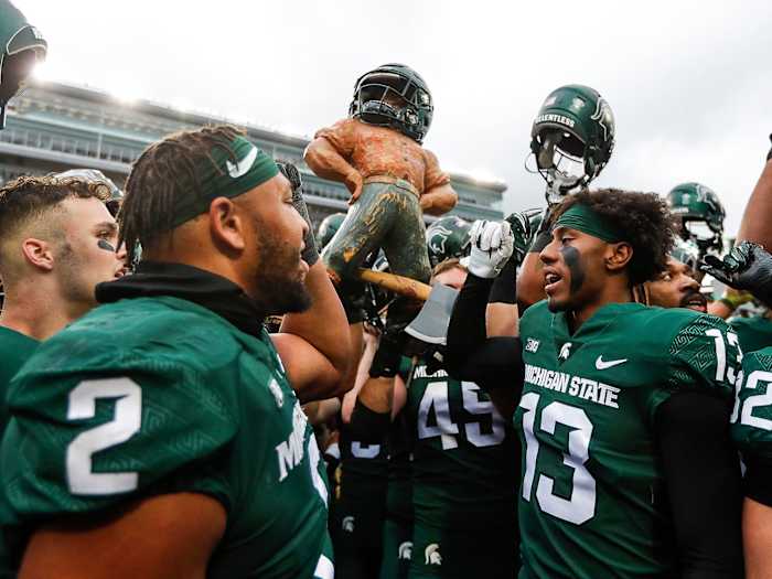 Michigan State football lifts the Paul Bunyan trophy